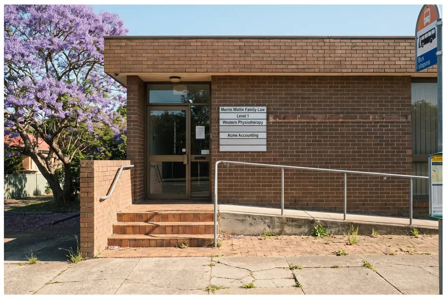 The street entrance at 88 Station Street, a brick building with steps and a ramp to the door