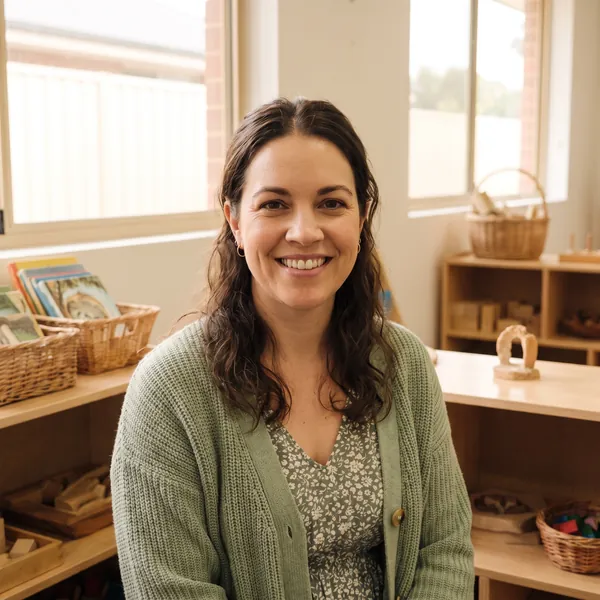 Carmen Ruiz, the kindy teacher, smiling in the kindy room.