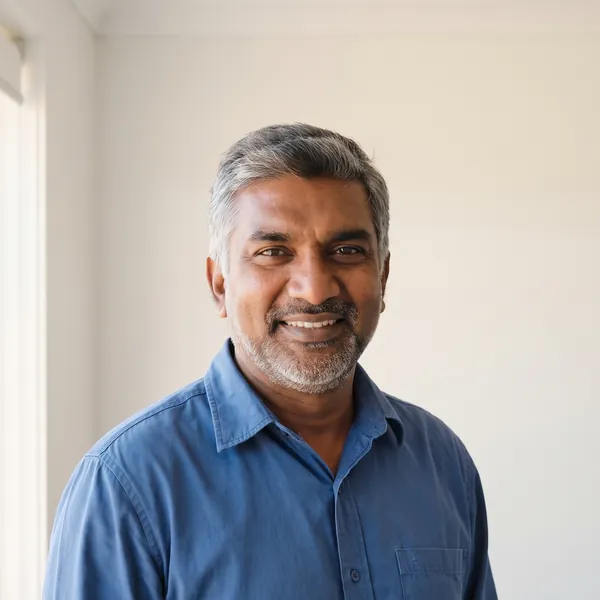 Rohan Mehta, smiling, in a blue shirt