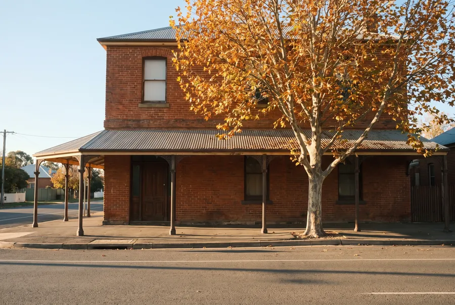 The two-storey red-brick building at 112 Summer Street, with a verandah over the footpath and a plane tree out the front